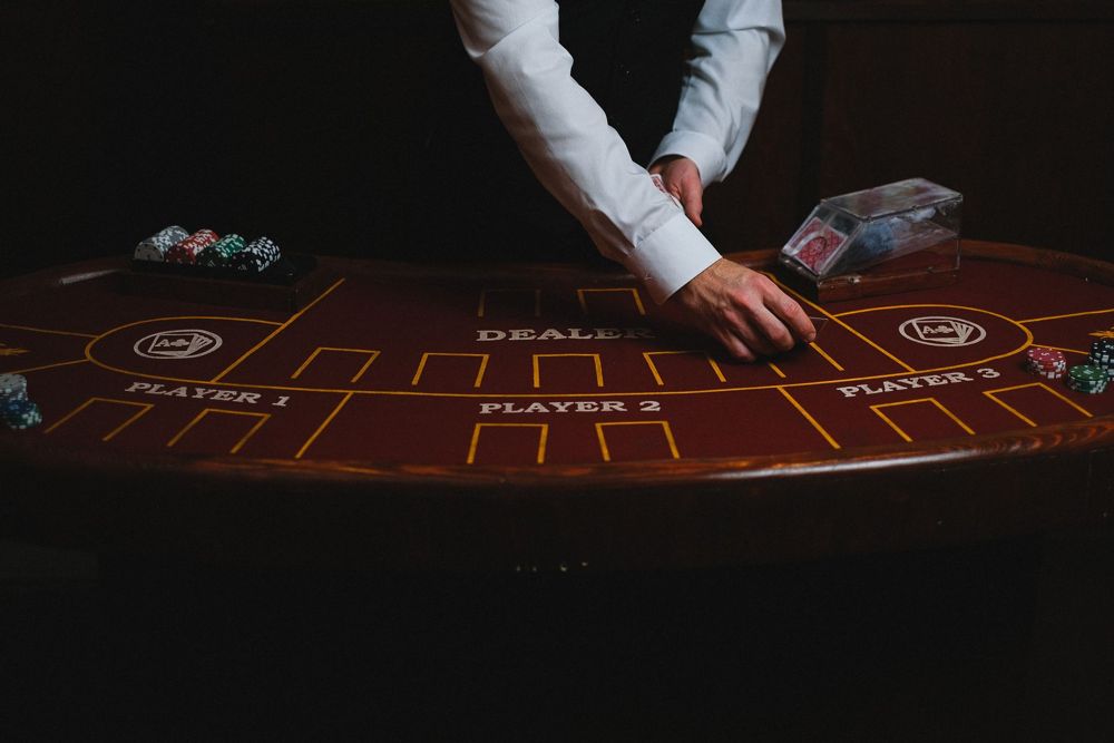 A croupier's hands at a card table